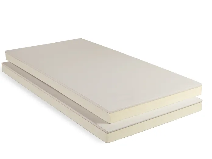 Beige and white layered mattress against a white background.
