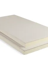 Beige and white layered mattress against a white background.