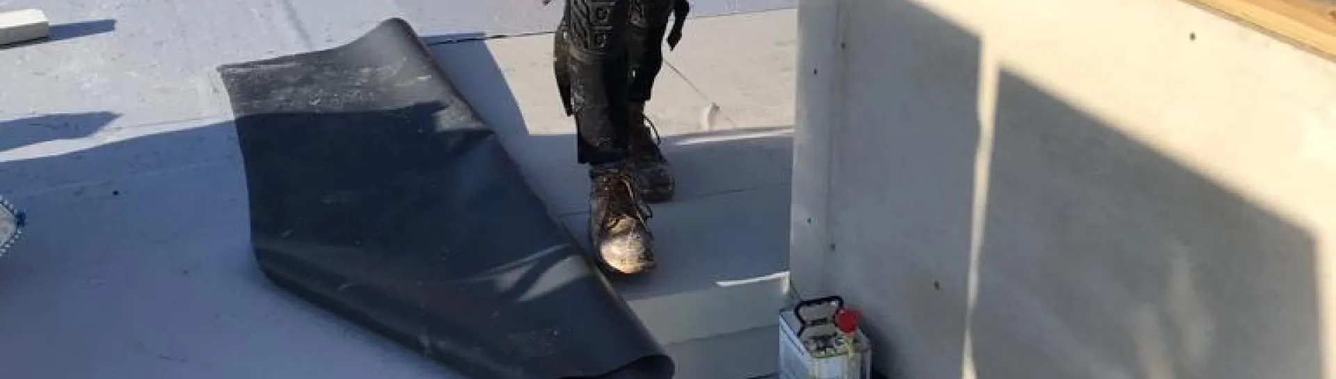 Contractor installing Powerdeck F within single ply membrane waterproofing system