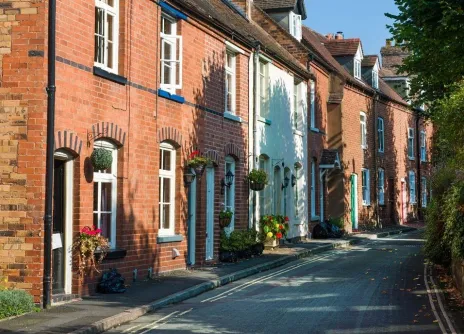 UK housing street with trees and green space opposite promoting low carbon homes