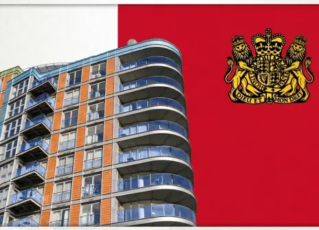 Modern building with curved balconies against a red flag with a golden emblem.